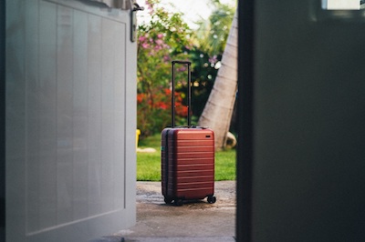 rolling luggage through doorway